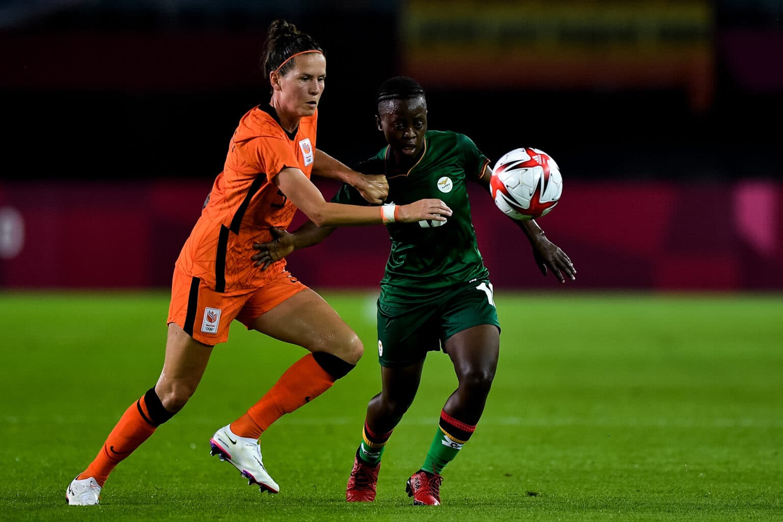 RIFU, JAPAN - JULY 21: Merel van Dongen of the Netherlands and Avell Chitundu of Zambia battle for possession during the Tokyo 2020 Olympic Football Tournament match between Zambia and Netherlands at Miyagi Stadium on July 21, 2021 in Rifu, Japan (Photo by Pablo Morano/Orange Pictures) NOCNSF